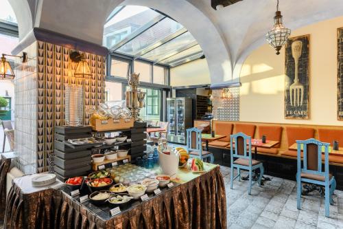 a buffet in a restaurant with food on a table at Maison Bistro & Hotel in Budapest