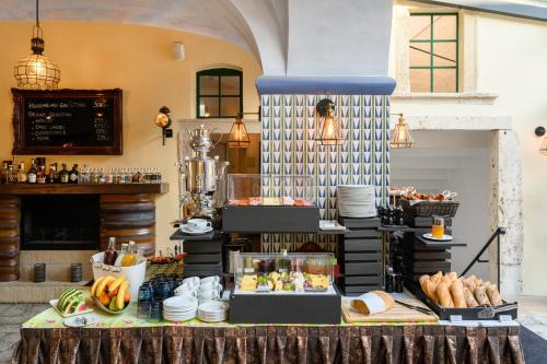 a table with food on top of it in a building at Maison Bistro & Hotel in Budapest