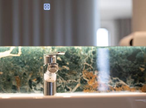 a close up of a bathroom sink with a tap at Aetherion Studios & Suites in Kalivia Poligirou