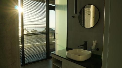a bathroom with a sink and a mirror at Hotel Nobilis Hall in K'obulet'i