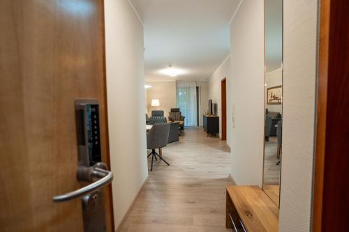 a hallway leading to a living room and dining room at Hotel CityHome am Kurpark in Bad Salzuflen