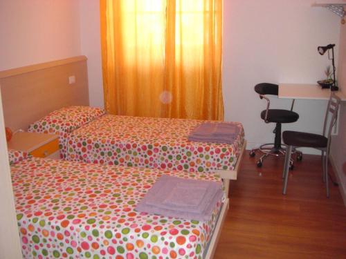 a room with two beds and a desk and a table at Venice 4 You in Mestre
