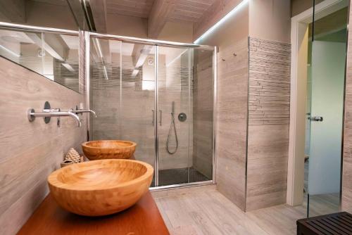 a bathroom with two wooden sinks and a shower at Judeka Agriresort in Caltagirone