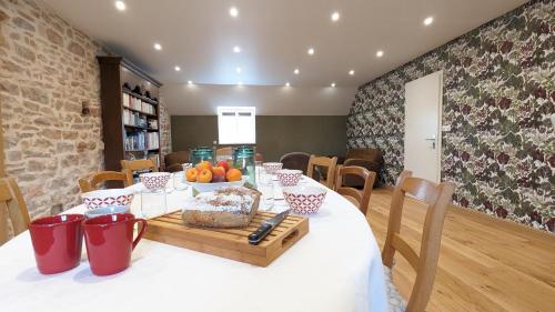 a dining room with a table with food on it at L'orcheran in Vielverge
