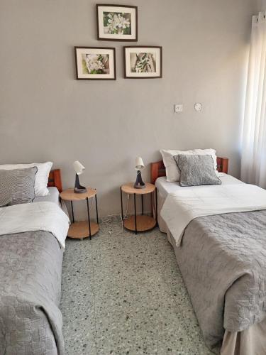 two beds in a room with two lamps on tables at Ibex Hill Apartment- Power backup in Lusaka