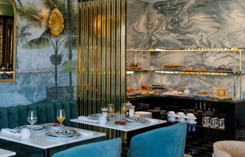 une salle à manger avec deux tables et des assiettes de nourriture dans l'établissement 1877 Estrela Palace, à Aveiro