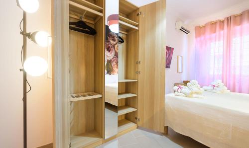 a bedroom with a closet with a bed and shelves at PeoniaMaximaHouse -Piazza Bologna- in Rome