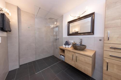 a bathroom with a sink and a mirror at Chalet "Villa Marlene" in Zell am See
