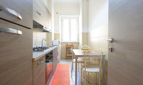 a small kitchen with a table and chairs in it at PeoniaMaximaHouse -Piazza Bologna- in Rome
