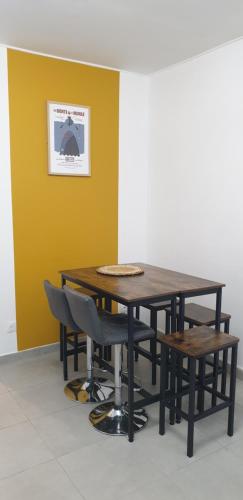 a wooden table and chairs in a room at Maison à deux pas de l'hôtel de ville in Calais