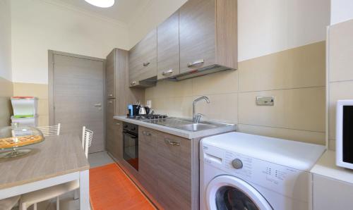 a kitchen with a washing machine and a sink at PeoniaMaximaHouse -Piazza Bologna- in Rome