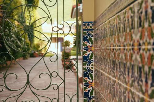 a iron gate with a view of a garden at Hotel Boutique La Candela in Salta