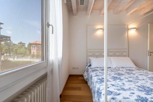 a bedroom with a bed and a large window at Clock's 2 bedrms 2 baths big terrace loc13324 in Venice-Lido
