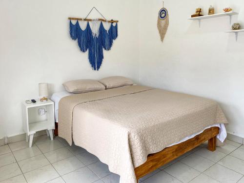 a bedroom with a bed with a blue tiled floor at Rincón Caribeño - Amplio estudio en Cozumel in Cozumel