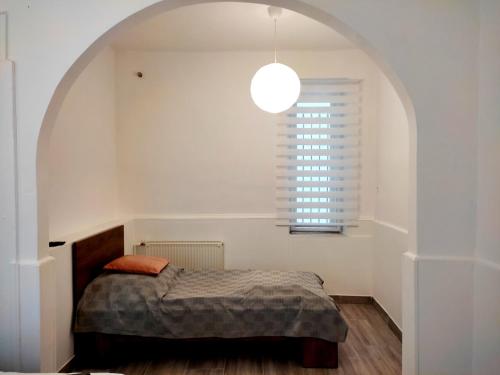 a bedroom with a bed and a large window at DunapArt Apartment in Vác