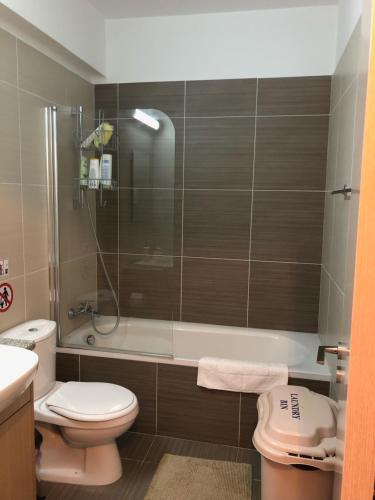a bathroom with a shower and a toilet and a sink at Mythical Sands Resort - Maria in Protaras