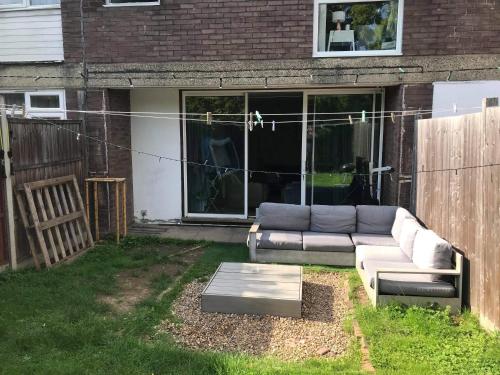 a couch sitting in the backyard of a house at Luxury House in heart of South London in London