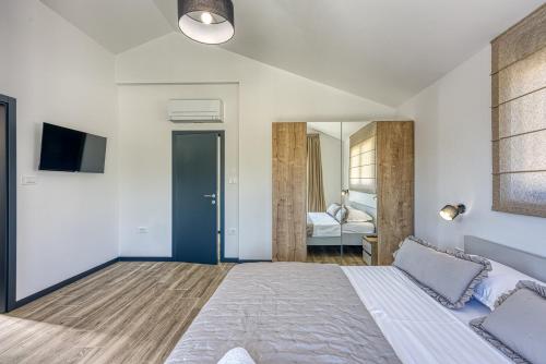 a bedroom with a large bed and a mirror at Villa Ivana with Private Pool in Nova Vas