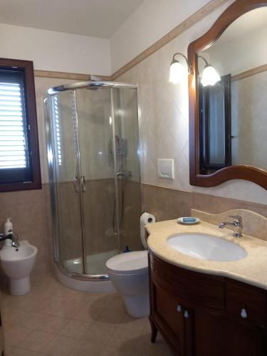 a bathroom with a shower and a sink and a toilet at Casa di Ale in Trepuzzi