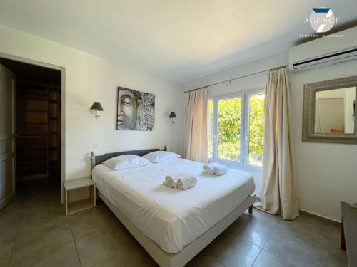 a bedroom with a bed with two towels on it at Villa Gaïa in Sainte-Maxime