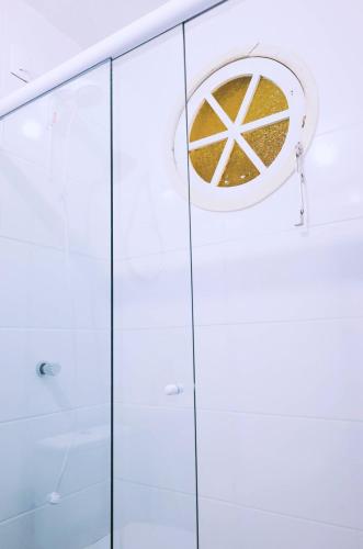 a shower with a glass door with a peace sign on it at Sea Wolf Hostel - Lagoa da Conceição in Florianópolis