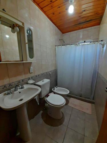 a bathroom with a sink and a toilet and a shower at Casitas del Sol in Caseros