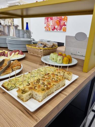 a buffet with sandwiches and other food on a table at Hotel Arte Mare in San Vito lo Capo