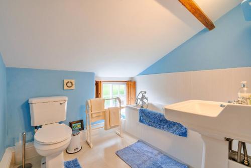 a bathroom with a white toilet and a sink at Finest Retreats - Marmaduke Cottage in Sancton