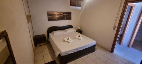 a small bedroom with a bed with two pillows on it at Il Casale Appartament&Rooms in Burgio