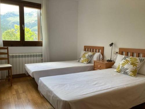 Ένα ή περισσότερα κρεβάτια σε δωμάτιο στο Acogedora Morada de Montaña