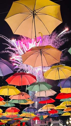 a bunch of umbrellas flying in the air with fireworks at Estudio TORROX PLAYA- vistas al mar y piscina in Torrox Costa