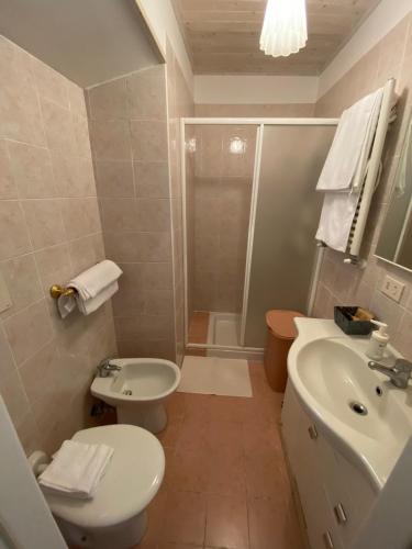 a bathroom with a white toilet and a sink at Da Nonna Puni in Orvieto