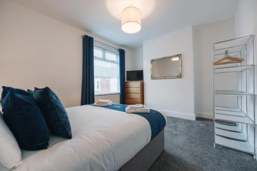a bedroom with a large bed and a tv at Hanson House in Redcar