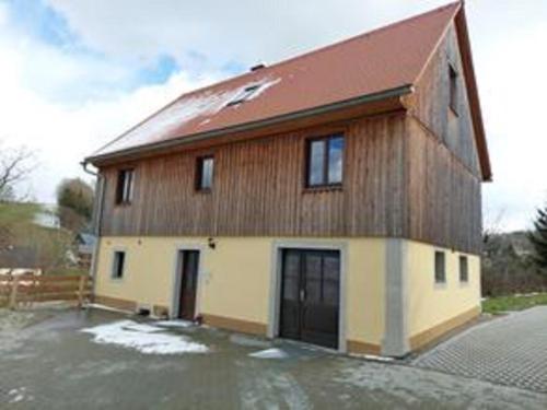 a large house with a brown and white at Ferienhaus Alpaka Glück in Frauenstein