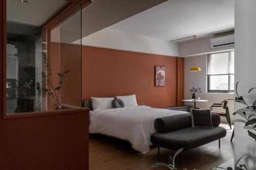 a bedroom with a bed and a chair at Lin Apartments by Olala Homes in Taipei