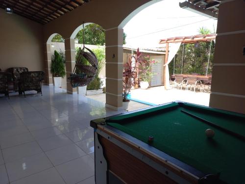 a pool table in a room with a patio at Casa de temporada Raio de sol in Piranhas