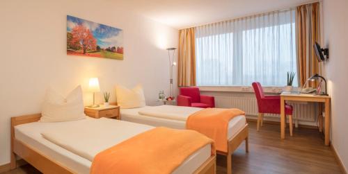 Postel nebo postele na pokoji v ubytování Heinrich Pesch Hotel