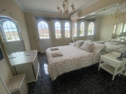 sypialnia z łóżkiem i dużym lustrem w obiekcie Villa Ivanlore w mieście Las Palmas de Gran Canaria