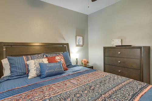 a bedroom with a bed with pillows and a dresser at Cozy Norman Home 4 Mi to Oklahoma University! in Norman