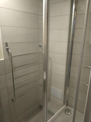 a shower with a glass door in a bathroom at 124A Castle Street Hinckley in Hinckley