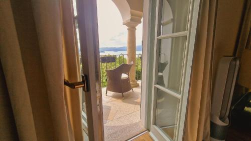 a door to a balcony with a view of a patio at Villa Antica Colonia SPA & Wellness in Pettenasco