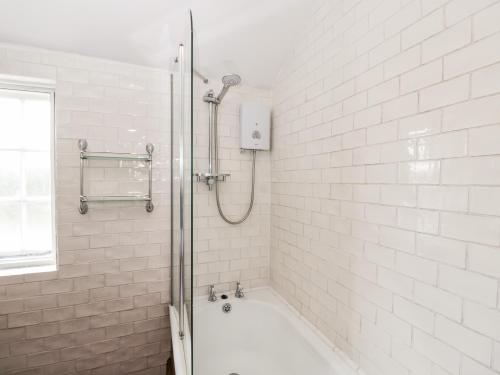 a bathroom with a shower and a bath tub at Fourways in Pewsey