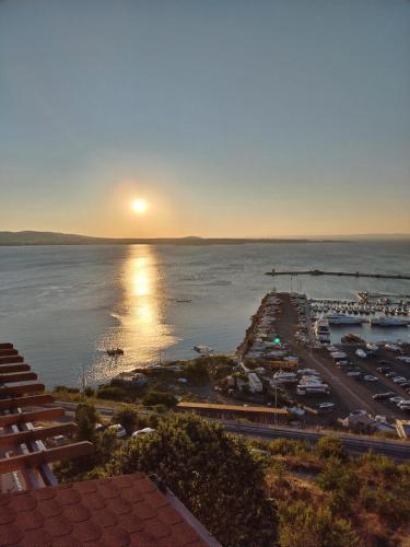 a view of a harbor with the sun setting over the water at Guest House Hetodon in Sozopol