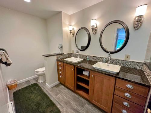 a bathroom with two sinks and two mirrors at FV44 tastefully updated single level with AC, WiFi in Bretton Woods