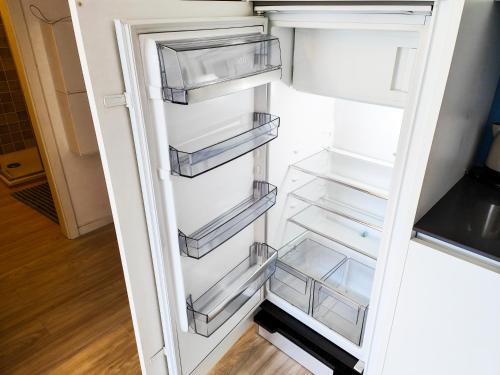 an empty refrigerator with its door open at Brissaghino al Lago 5* in Brissago