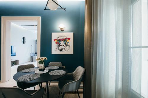 a dining room with a black table and chairs at NOZON Apartments & Wellness in Odorheiu Secuiesc