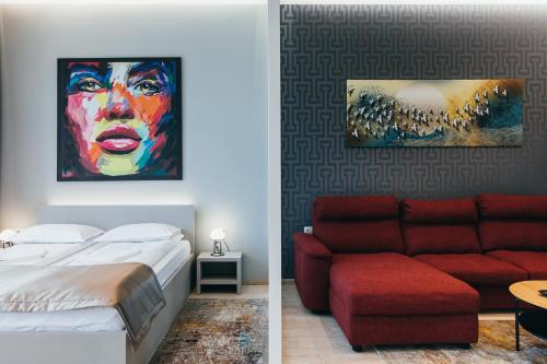 a bedroom with a bed and a painting of a woman at NOZON Apartments & Wellness in Odorheiu Secuiesc