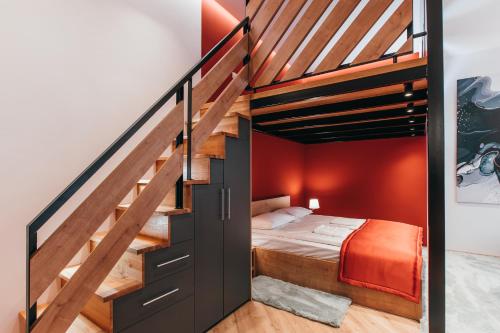 a bedroom with a bunk bed and a staircase at NOZON Apartments & Wellness in Odorheiu Secuiesc