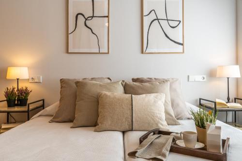 a living room with a bed with pillows at AQUI en Madrid in Madrid