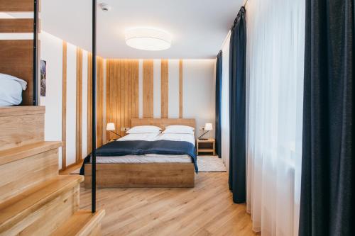 a bedroom with a bed in a room at NOZON Apartments & Wellness in Odorheiu Secuiesc